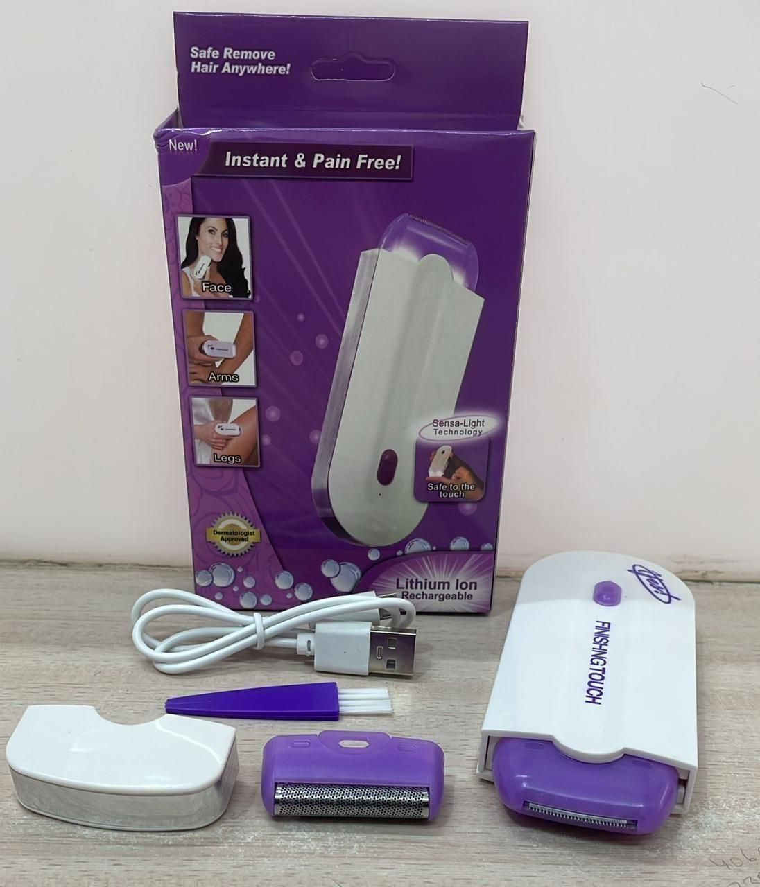 Purple and white hair removal device with packaging on a light surface