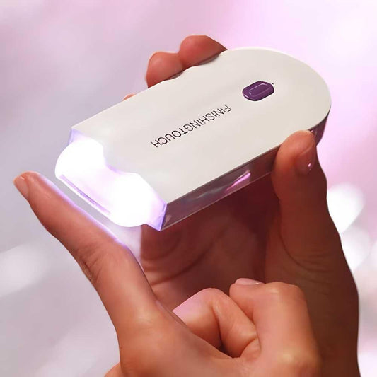 Hand holding a white UV light device with 'FINISHING TOUCH' branding on a blurred background