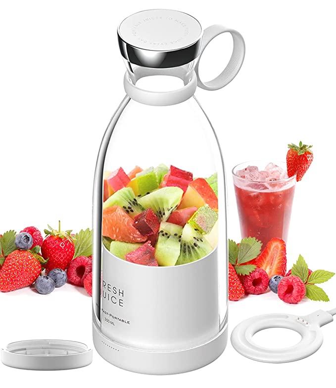 White juice extractor with fruits and a glass of juice on a white background