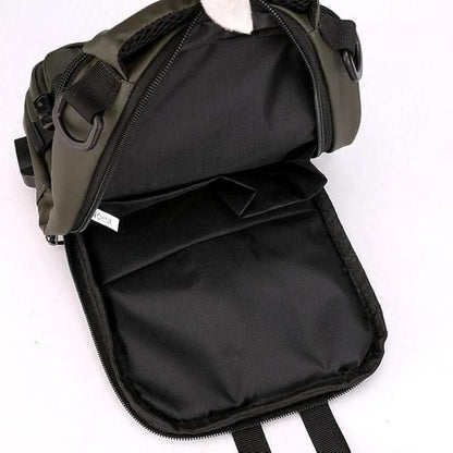 Black backpack with a green top section on a white background