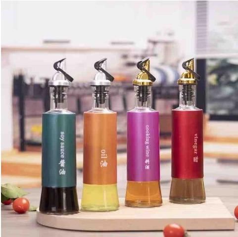 Four colorful oil bottles on a wooden board with a blurred kitchen background