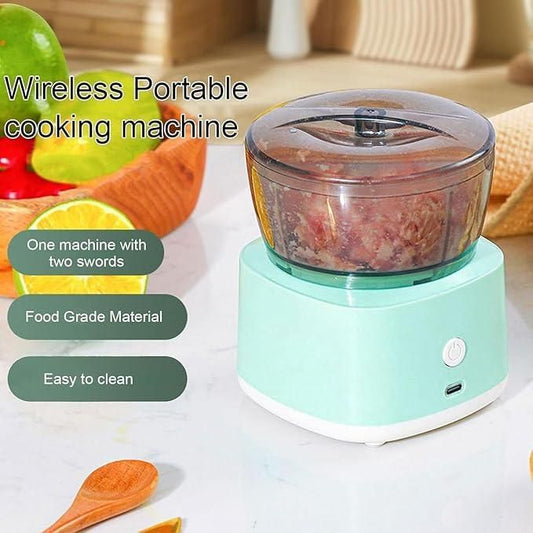 Wireless portable cooking machine with food inside, surrounded by fruits and a wooden spoon on a light background.